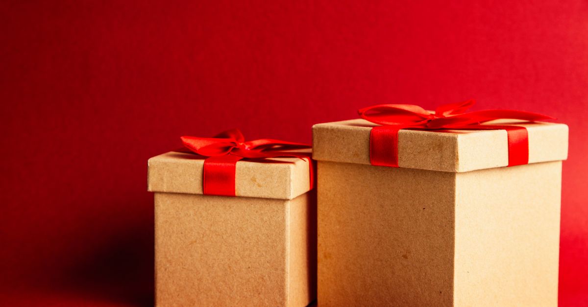 Two gift boxes with red ribbons on a vibrant red background.