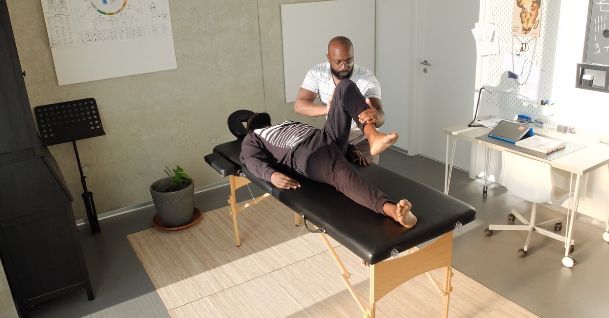 Therapist performing therapeutic massage in a clinic setting, emphasizing wellness and relaxation.