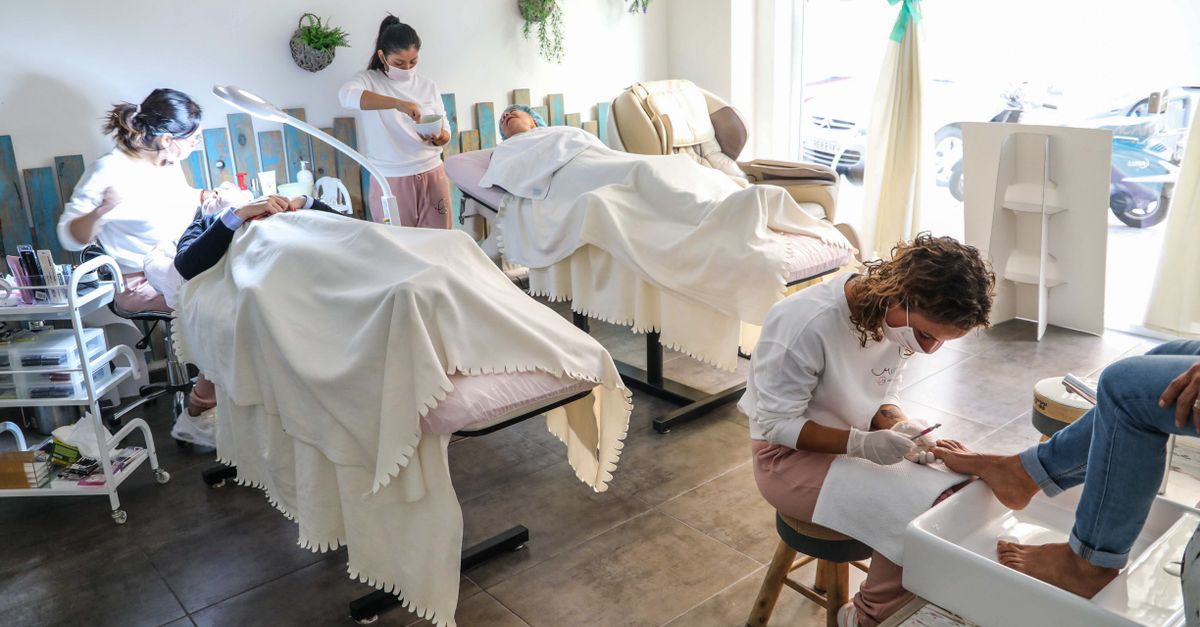 Peaceful spa scene with professionals giving facial and pedicure treatments in a well-lit salon.