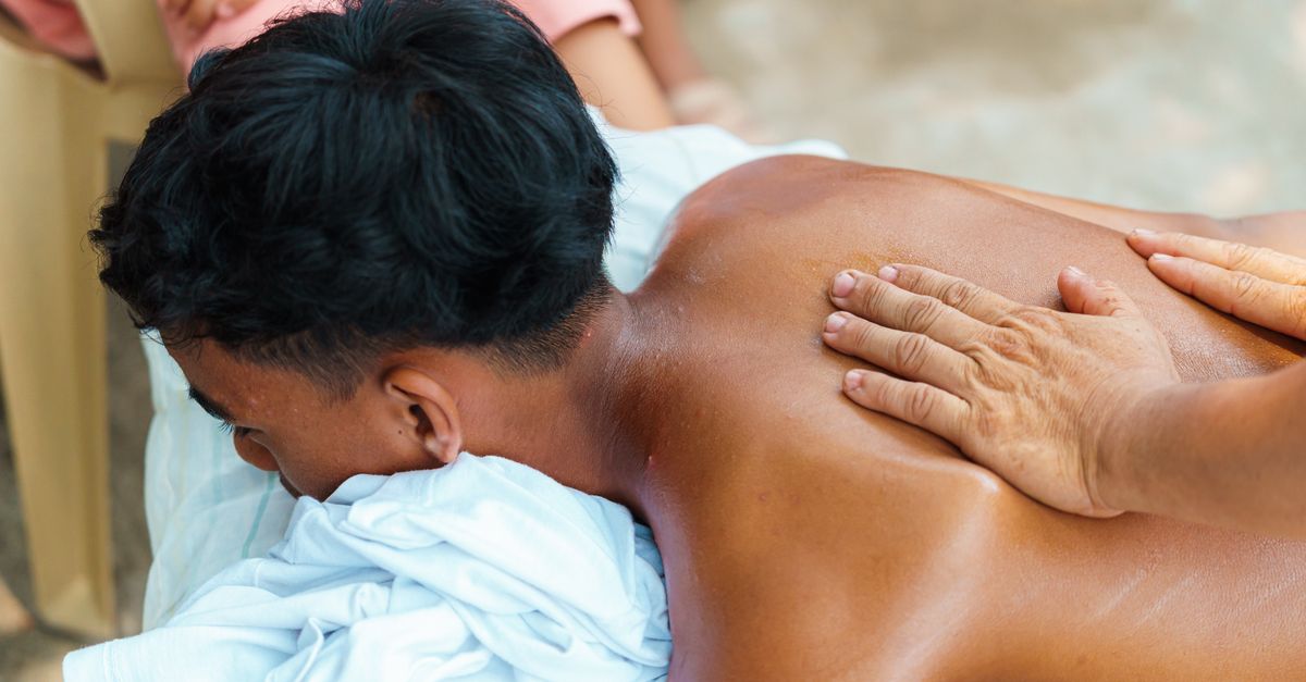 An outdoor therapeutic back massage on a sunny day, providing relaxation and relief.