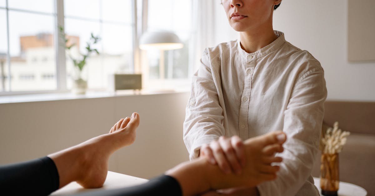 A woman receiving a foot massage indoors at a spa, promoting wellness and relaxation.