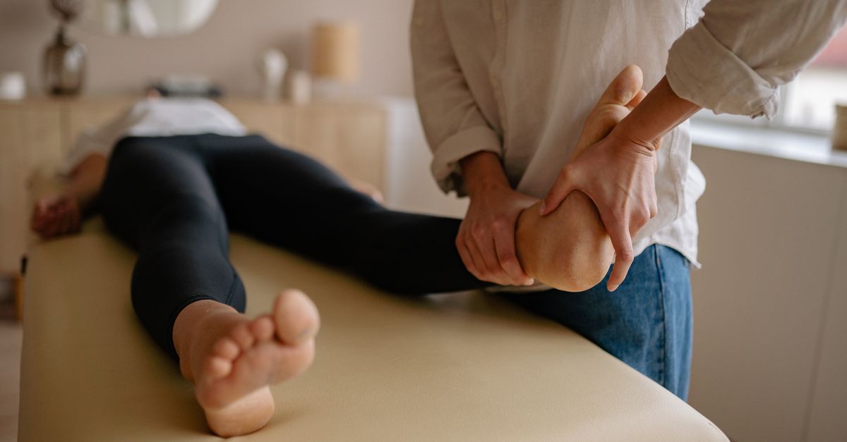 Close-up of a foot massage therapy session, showcasing relaxation and wellness indoors.
