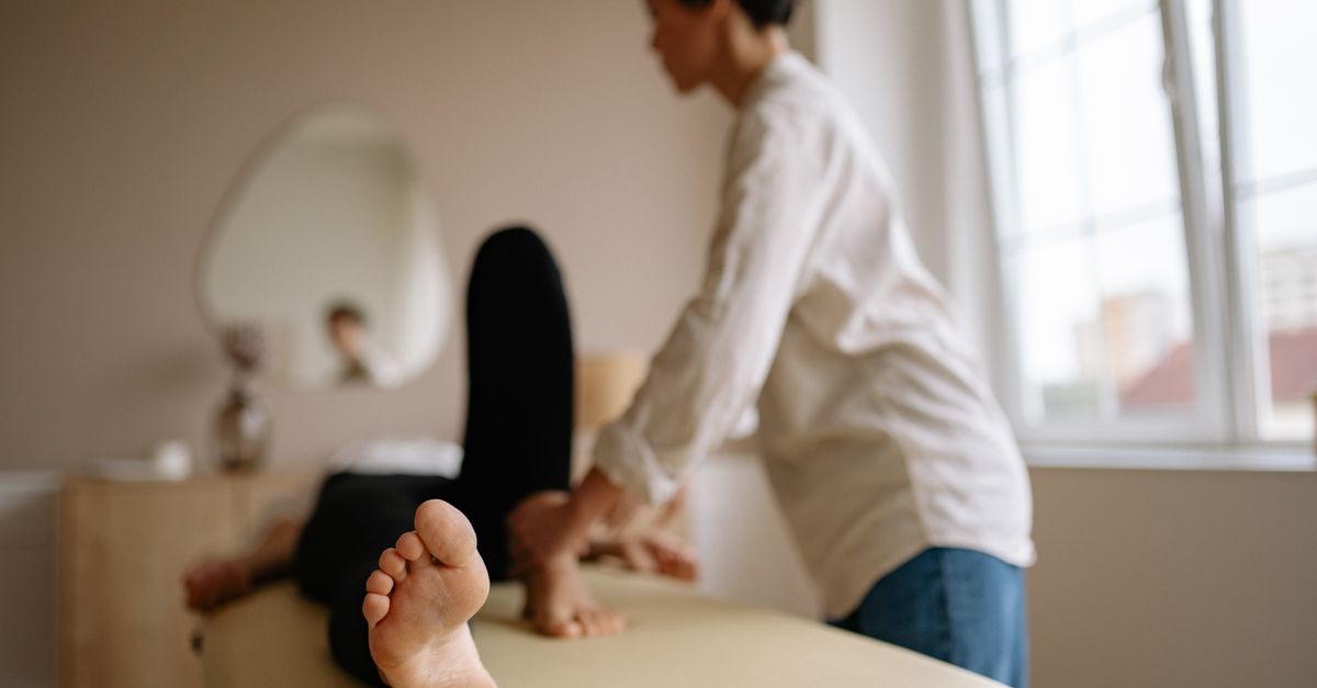 A calming foot massage in a serene indoor spa environment with natural light.