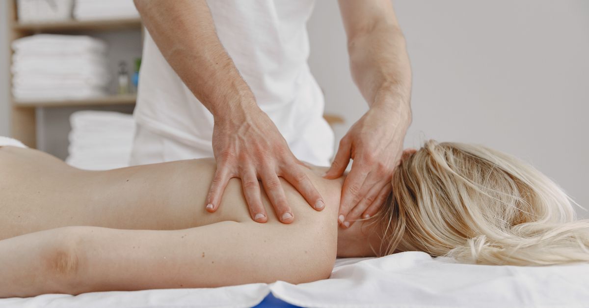 A tranquil massage session focusing on relaxation and self-care, featuring a woman receiving a back massage.