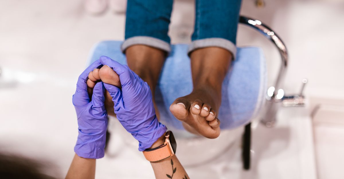Foot massage session in a beauty salon with a focus on relaxation and pampering.