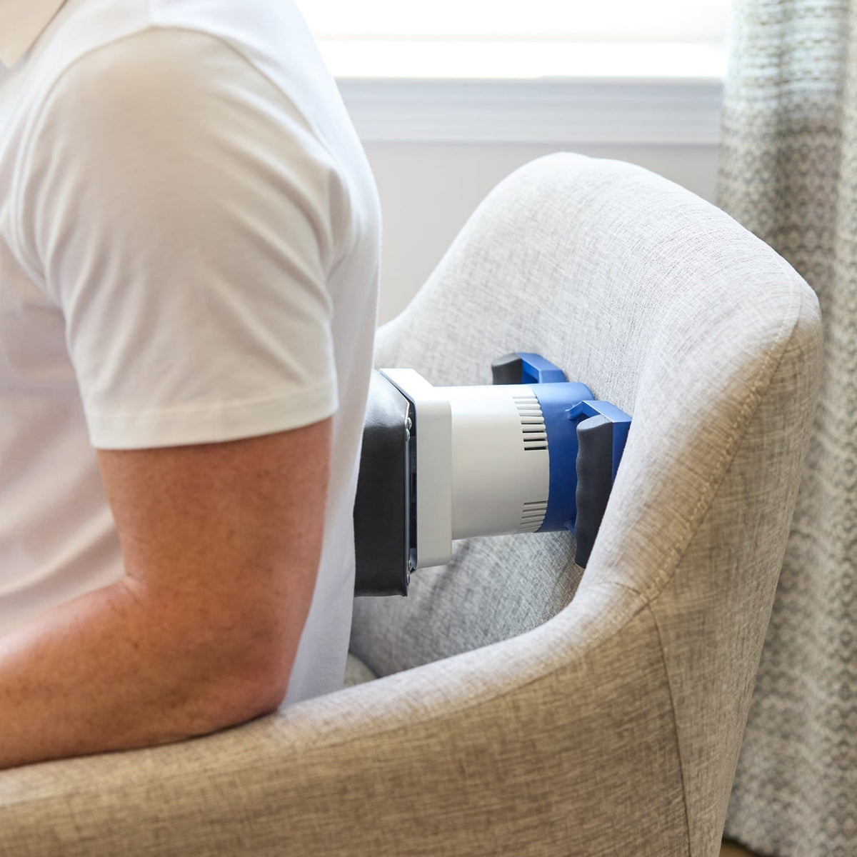 Person using a MedMassager Body Massager on the lower back.