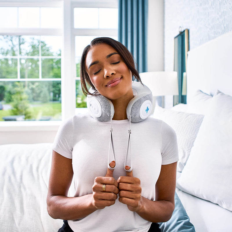 Woman resting with a MedMassager Neck Massager around her neck.