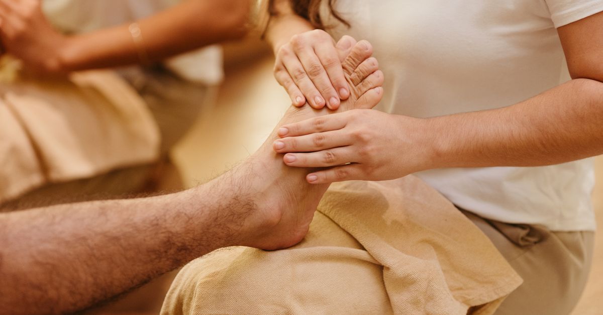 Close-up of a foot massage in a spa setting, highlighting relaxation and wellness.