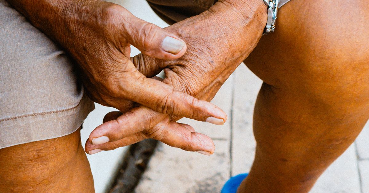 Close-up of elderly hands clasped in a relaxed position outdoors in Cebu City, Philippines.