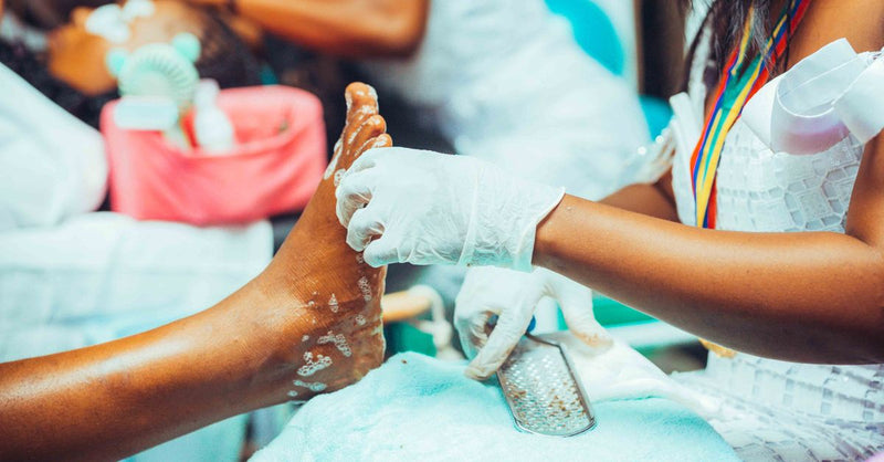 Close-up of a pedicure treatment being performed in a salon setting.
