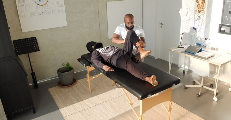 Therapist performing therapeutic massage in a clinic setting, emphasizing wellness and relaxation.