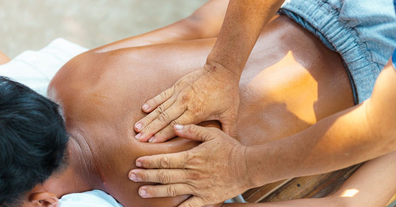 An outdoor massage therapy session focusing on relaxation and wellness with a professional masseur.