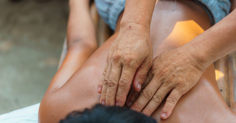 A serene outdoor massage therapy session focusing on relaxation and wellness.