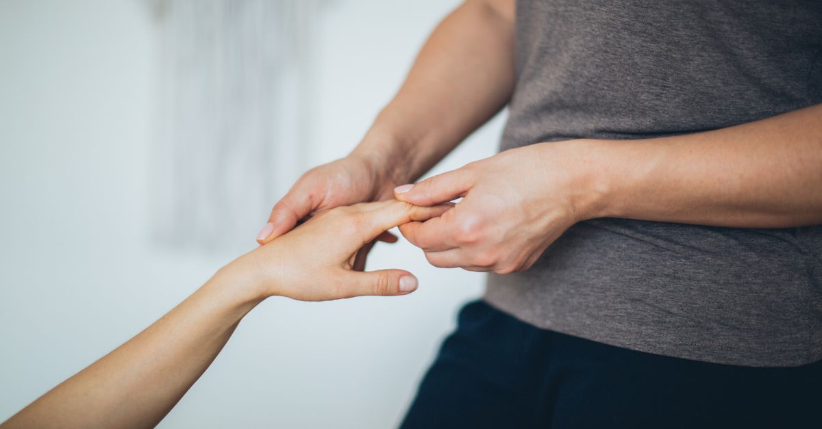Close-up of a hand massage in a calm indoor setting.