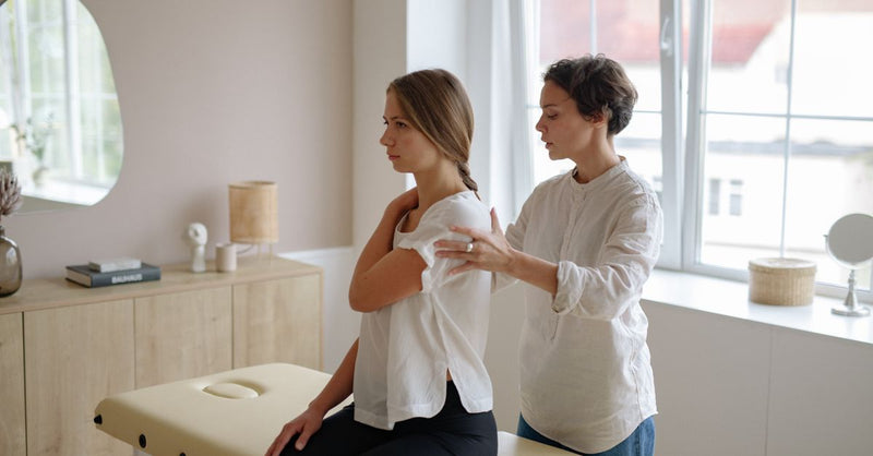A massage therapist providing a gentle therapy session in a calm indoor setting.